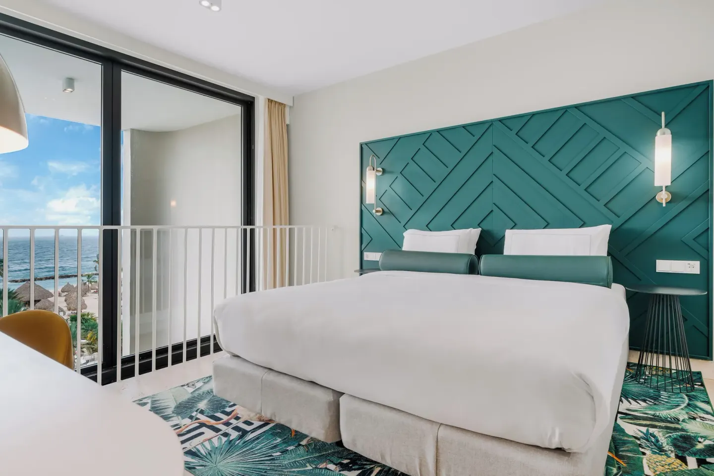 Ocean-view king guest room with balcony rail at Mangrove Beach Corendon Curacao Resort.
