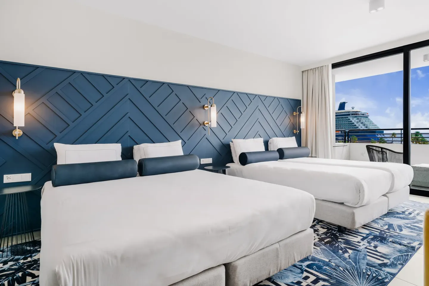 Two-bed ocean-view guest room with balcony at Mangrove Beach Corendon Curacao Resort.