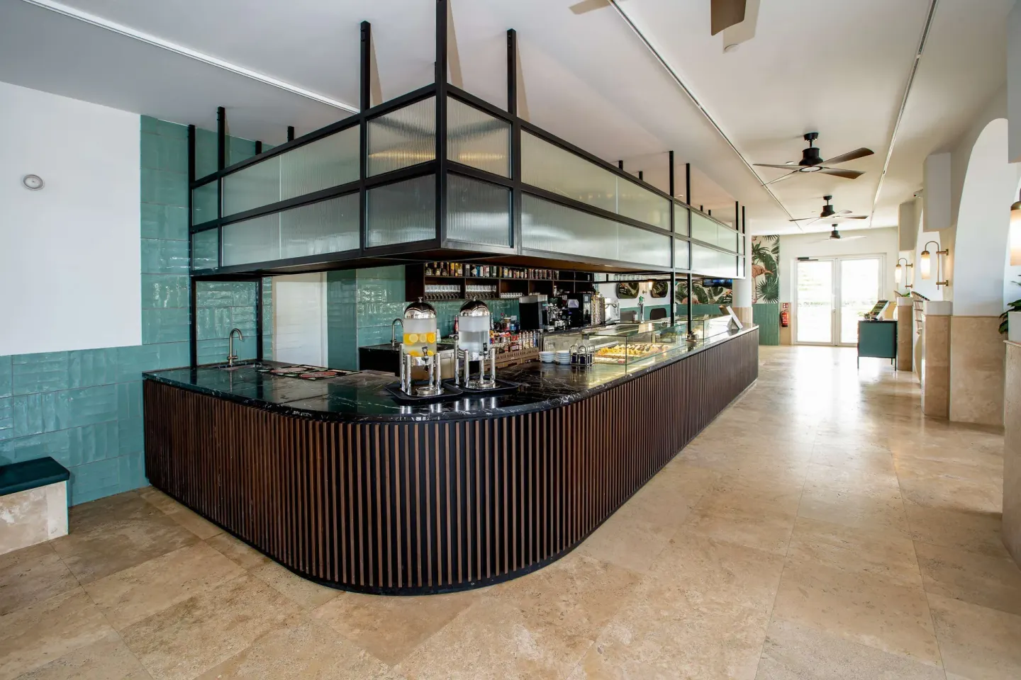 Lobby counter with drinks and pastry displays at Mangrove Beach Corendon Curacao Resort.