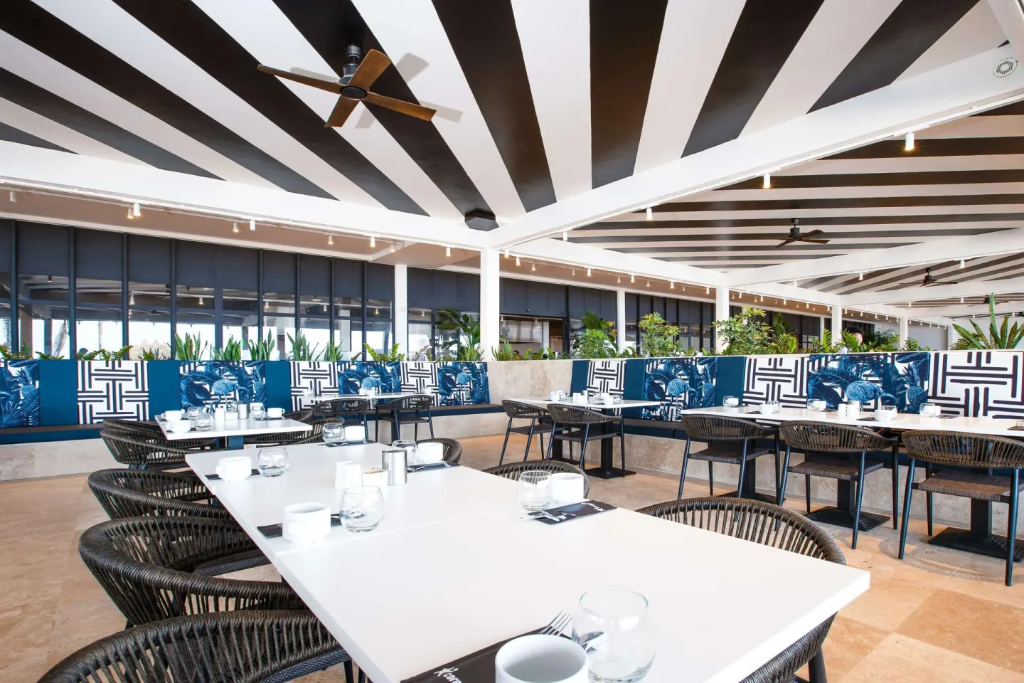 Modern restaurant dining room with patterned banquettes at Mangrove Beach Corendon Curacao Resort.