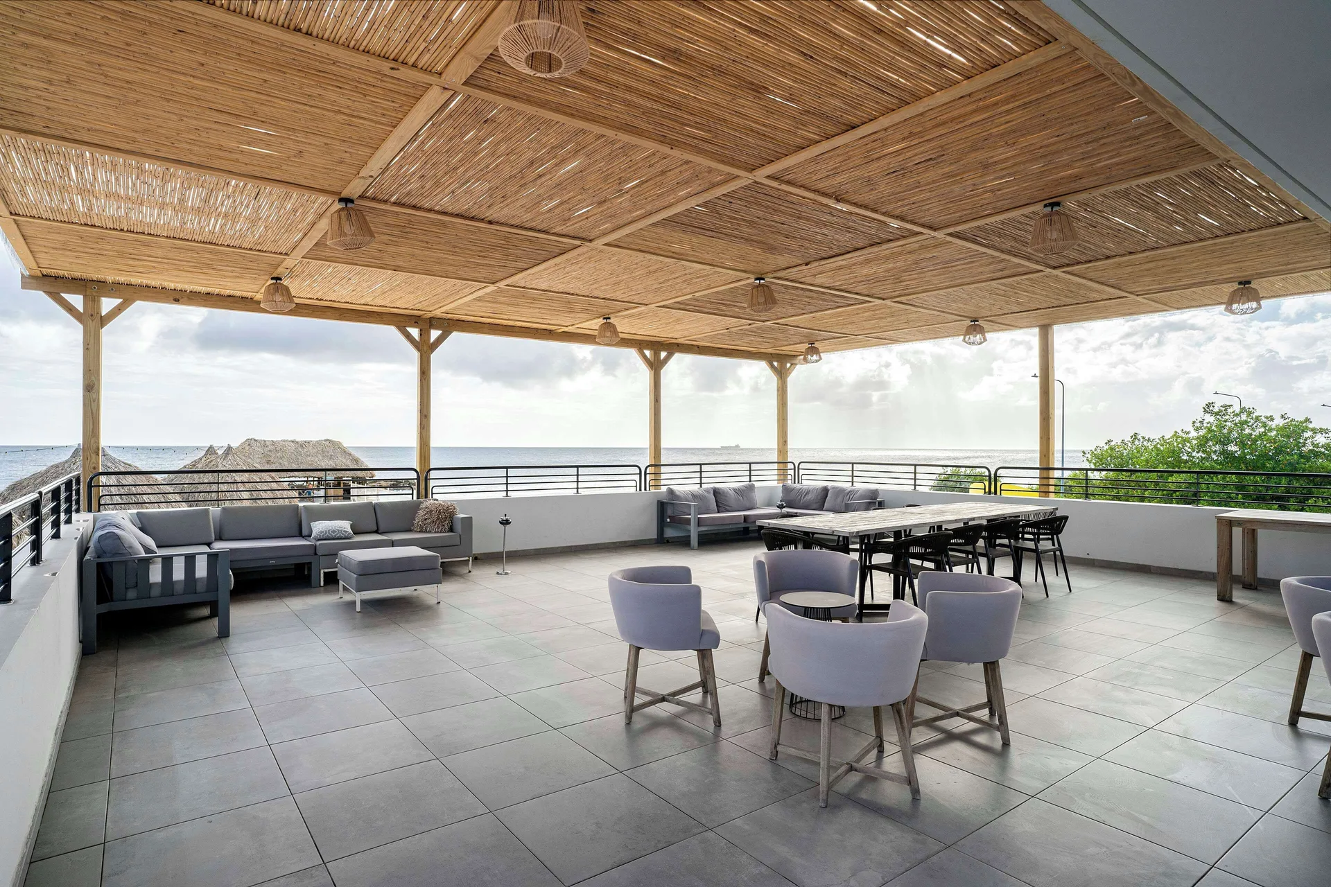 Open-air rooftop lounge with ocean views at Mangrove Beach Corendon Curacao Resort.