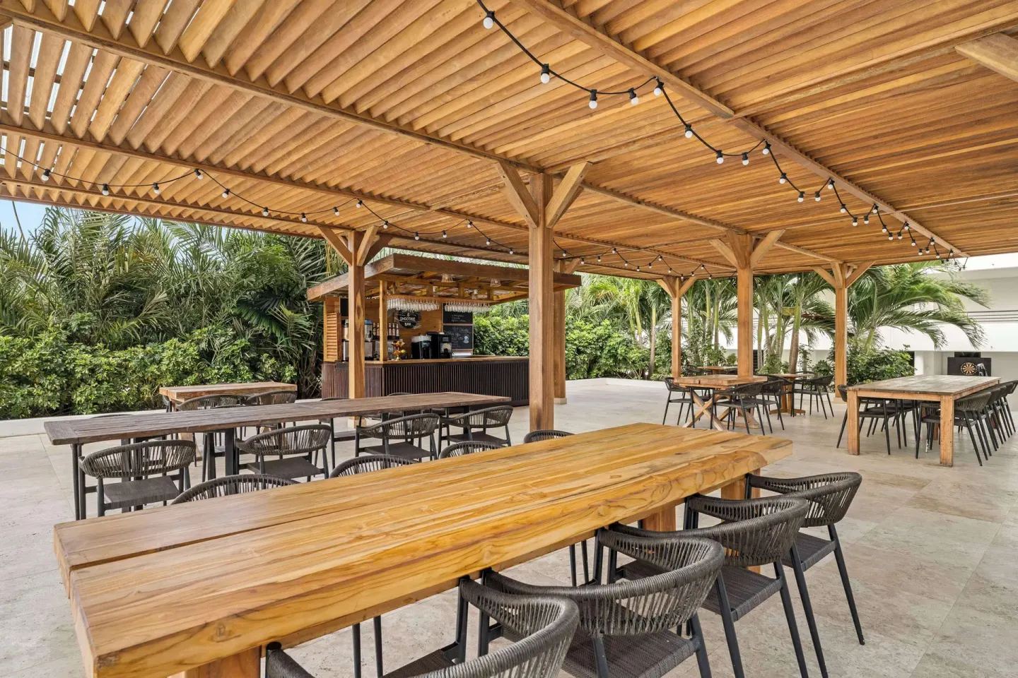 Outdoor bar and communal tables at Mangrove Beach Corendon Curacao Resort.