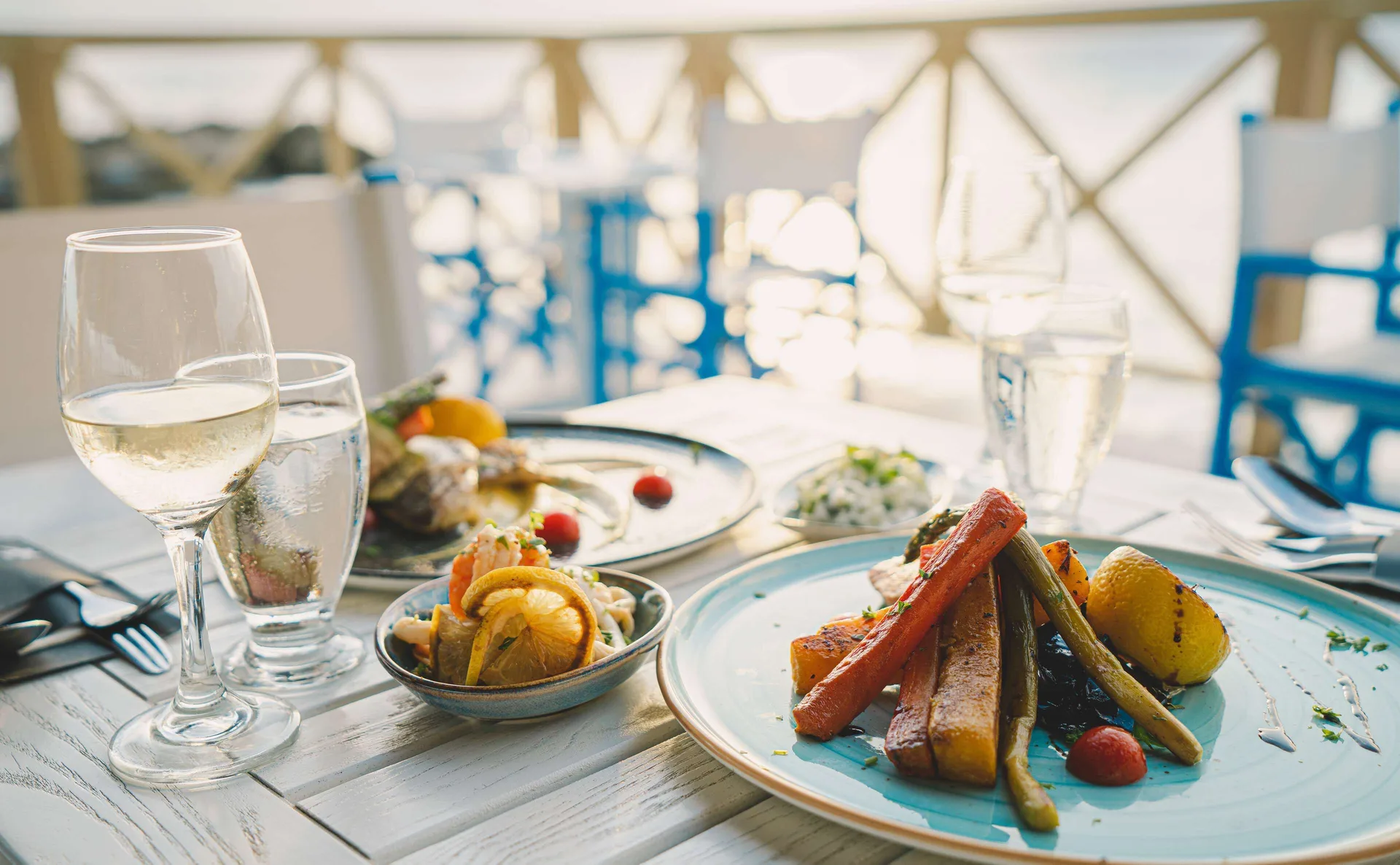 Plated seafood and vegetables by the water at Mangrove Beach Corendon Curacao Resort.