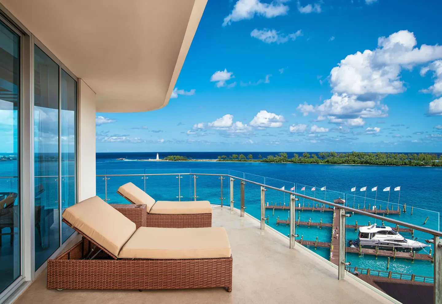 Balcony lounge chairs overlooking turquoise water at Margaritaville Beach Resort - Nassau.
