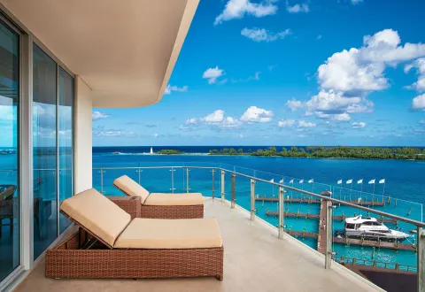 Balcony lounge chairs overlooking turquoise water at Margaritaville Beach Resort - Nassau.