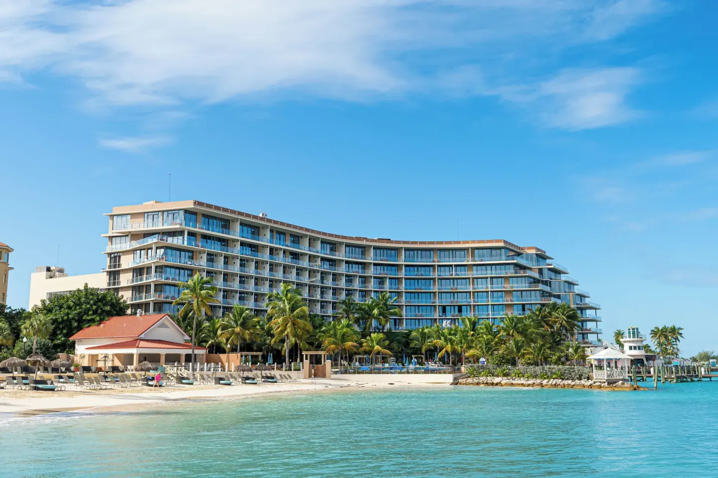 Beachfront resort building and turquoise water at Margaritaville Beach Resort - Nassau.