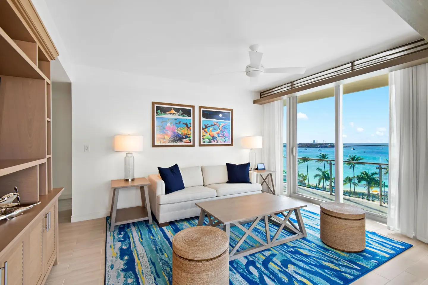 Guest suite living room with balcony ocean views at Margaritaville Beach Resort - Nassau.