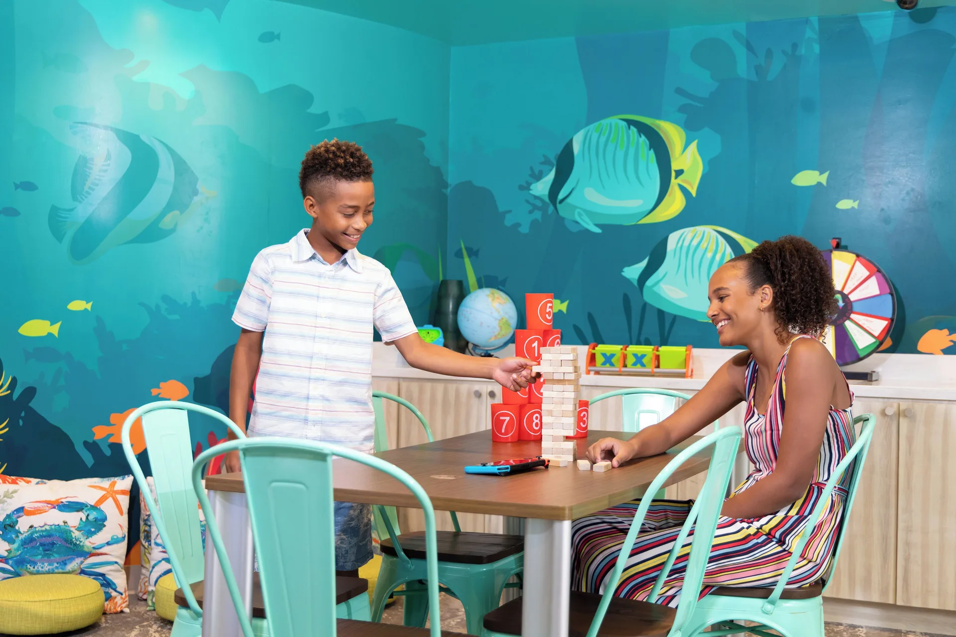 Children play a tabletop game in the kids club at Margaritaville Beach Resort - Nassau.