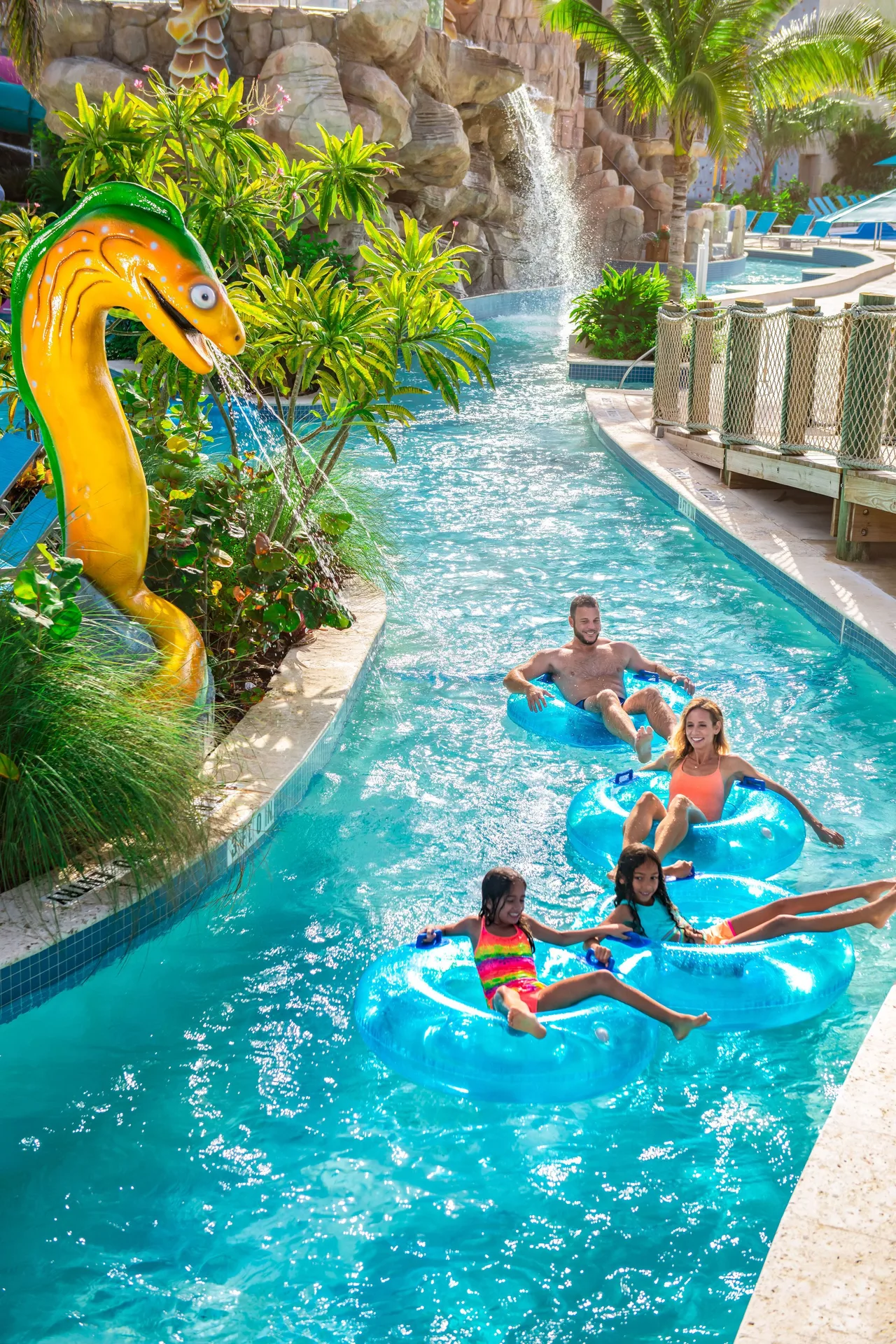 Family floating on inner tubes in the lazy river at Margaritaville Beach Resort - Nassau.