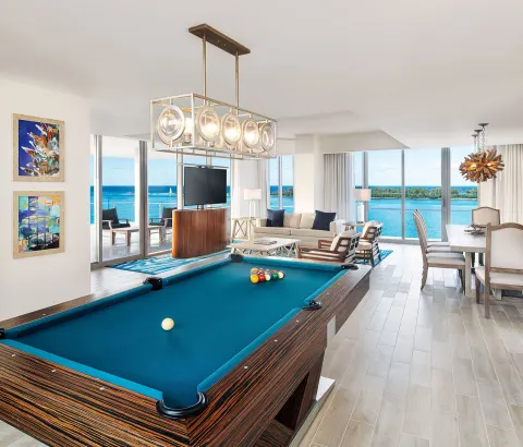 Oceanview suite living area with a pool table at Margaritaville Beach Resort - Nassau.