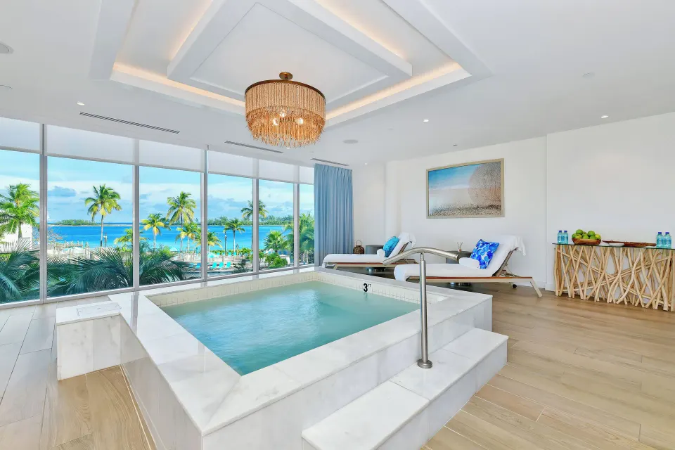 Spa soaking pool with lounge chairs and ocean view at Margaritaville Beach Resort - Nassau.
