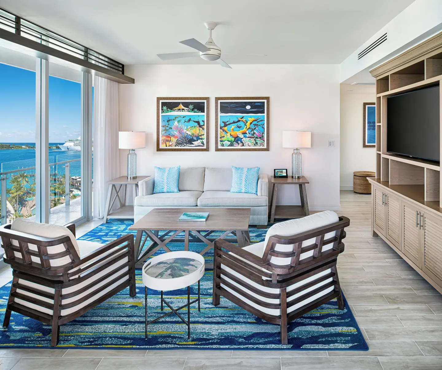 Spacious suite living room with ocean-facing windows at Margaritaville Beach Resort - Nassau.