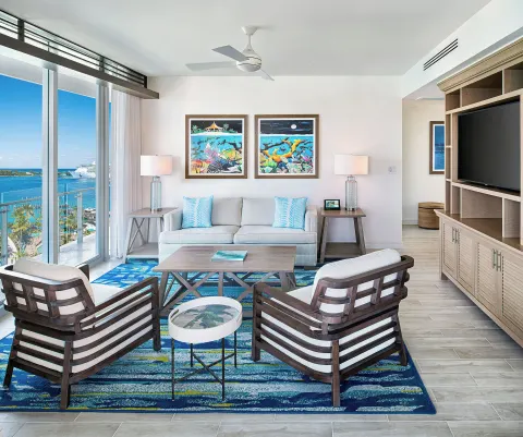 Spacious suite living room with ocean-facing windows at Margaritaville Beach Resort - Nassau.
