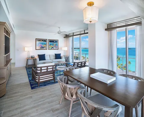Suite dining and living area with ocean windows at Margaritaville Beach Resort - Nassau.