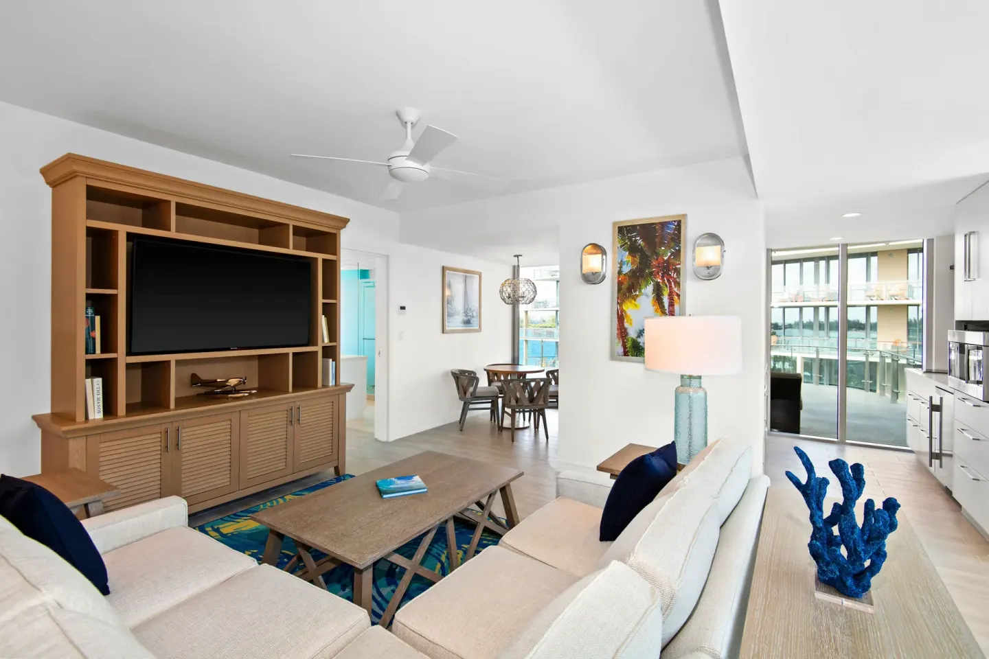 Suite living area with kitchen, dining table, and balcony at Margaritaville Beach Resort - Nassau.