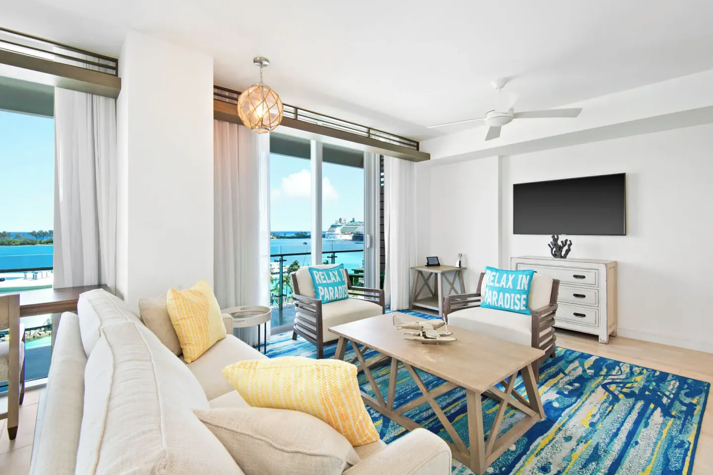 Suite sitting area with balcony harbor view at Margaritaville Beach Resort - Nassau.