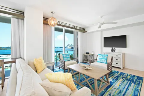 Suite sitting area with balcony harbor view at Margaritaville Beach Resort - Nassau.