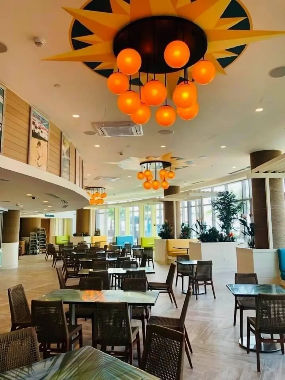 Indoor dining area with orange pendant lights at Margaritaville Beach Resort - Nassau.