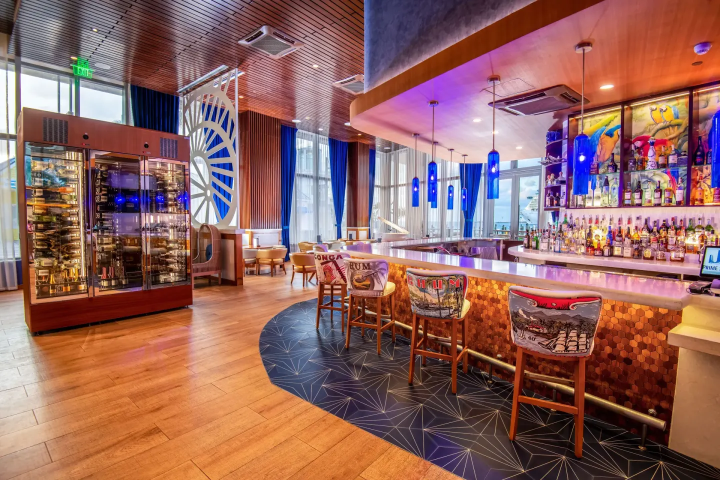 Bar with wine display and blue pendant lights at Margaritaville Beach Resort - Nassau.