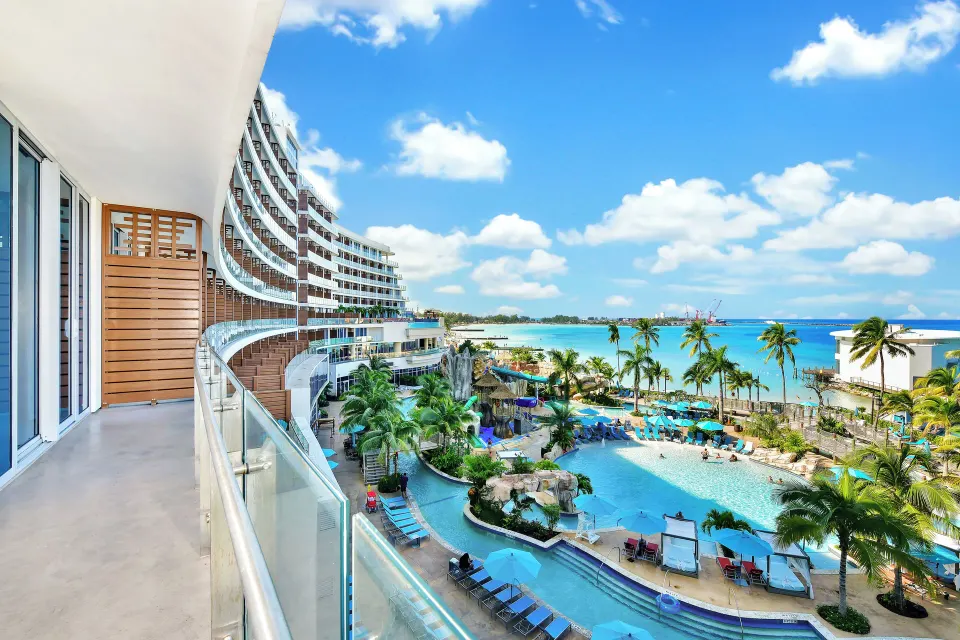 Curved balcony overlooking pools and ocean at Margaritaville Beach Resort - Nassau.