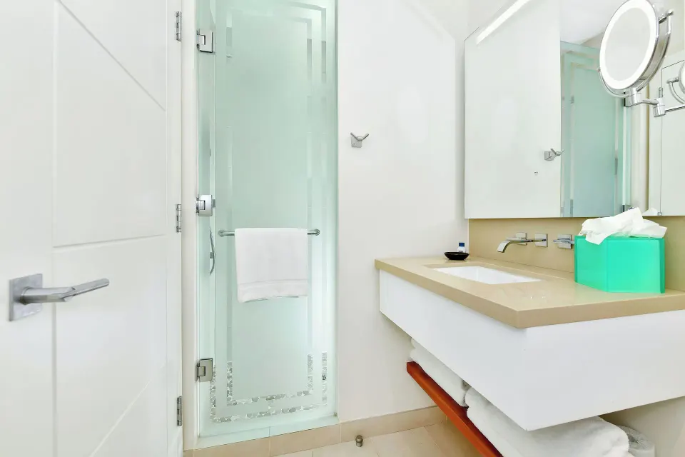 Guest bathroom with shower and vanity at Margaritaville Beach Resort - Nassau.