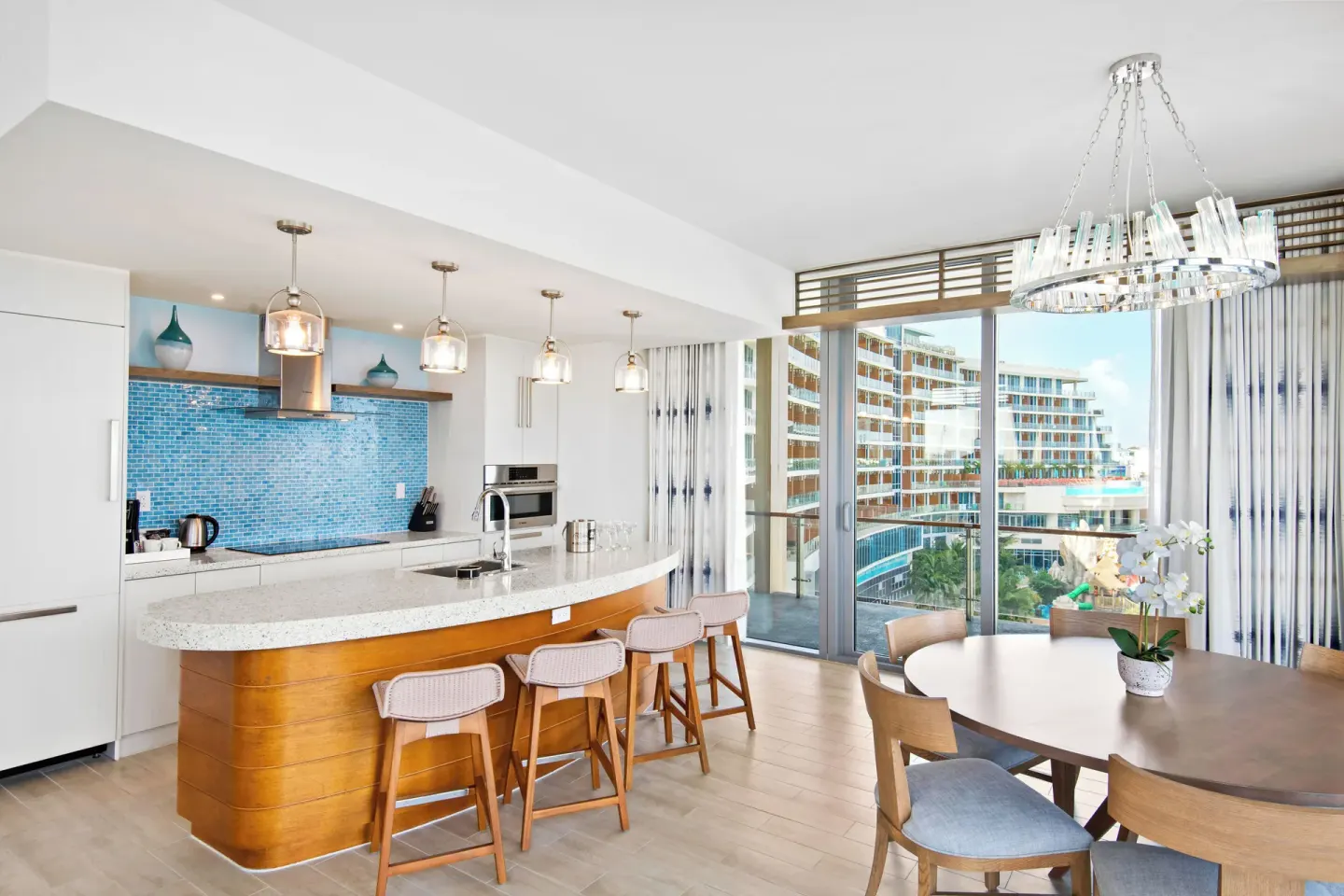 Oceanfront suite kitchen and dining area at Margaritaville Beach Resort - Nassau with balcony doors.