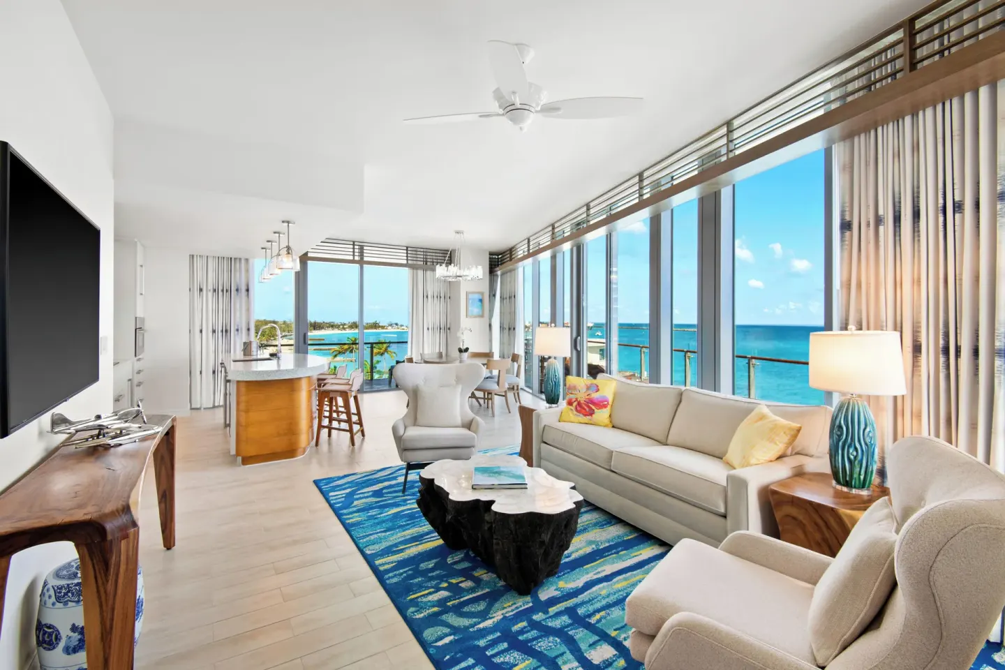 Oceanfront suite living room at Margaritaville Beach Resort - Nassau with seating and sea views.