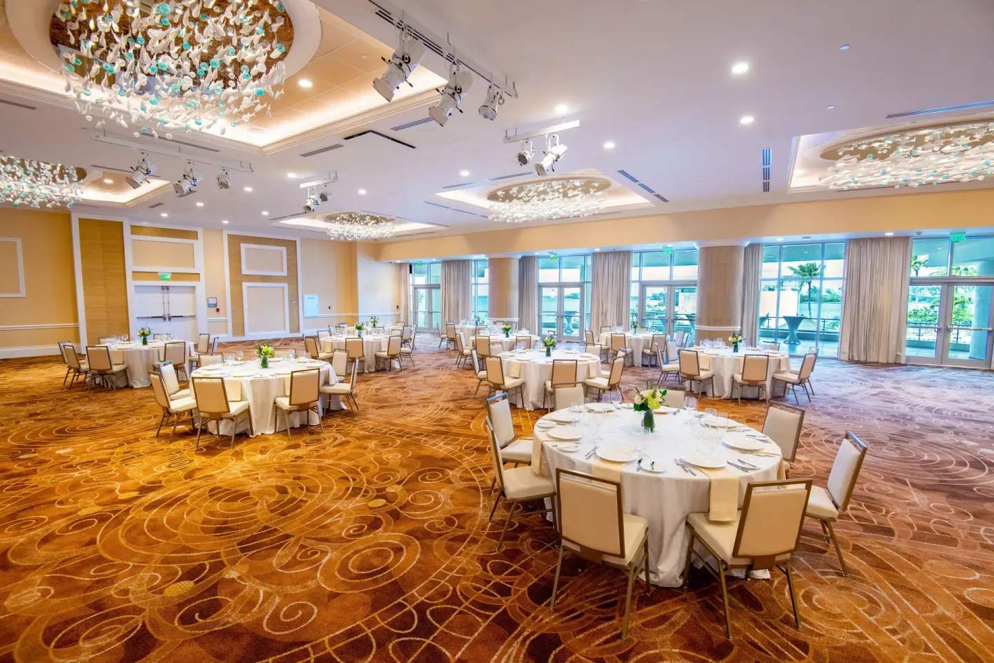 Ballroom with banquet tables and chandeliers at Margaritaville Beach Resort - Nassau.