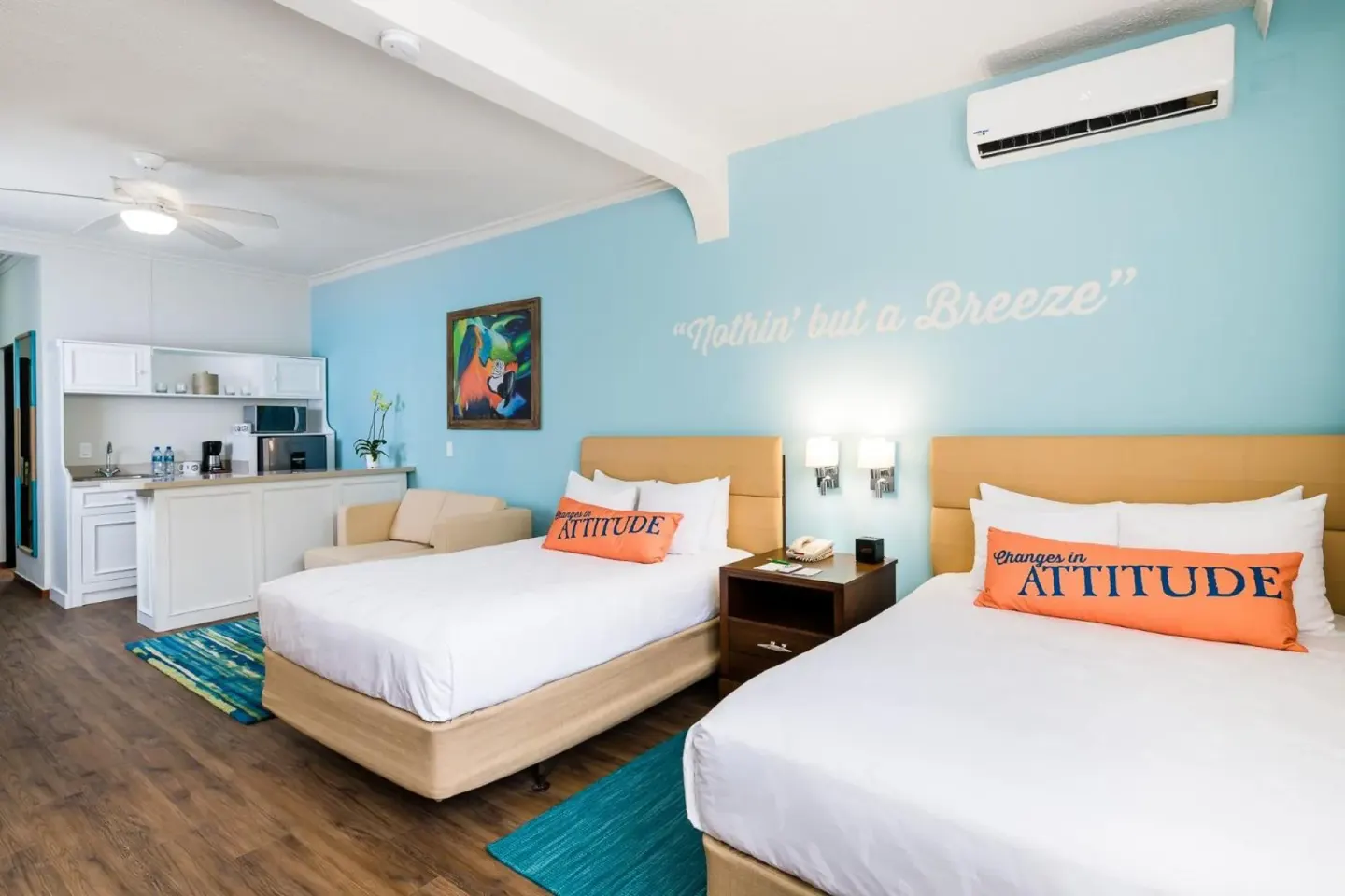 Two queen beds and a kitchenette in a guest room at Margaritaville Beach Resort Playa Flamingo.