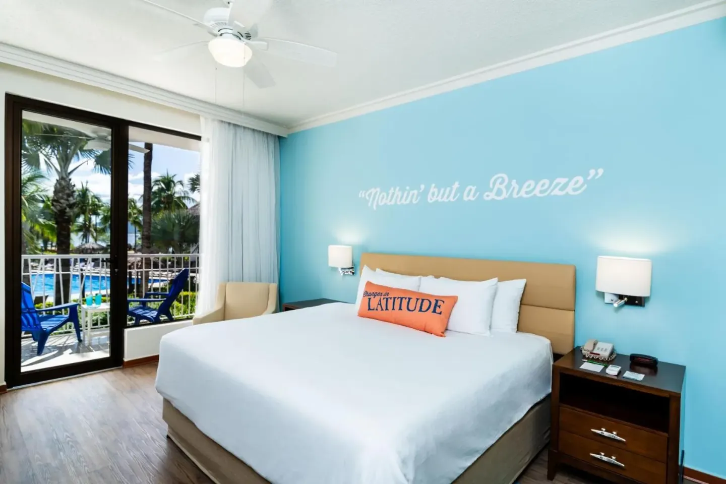 King bed guest room with balcony view at Margaritaville Beach Resort Playa Flamingo.