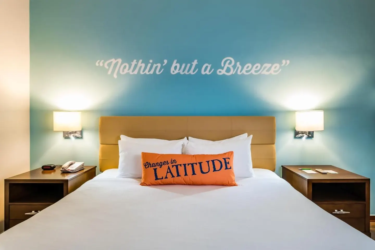 King bed with turquoise accent wall at Margaritaville Beach Resort Playa Flamingo.