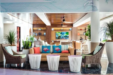Lobby seating with wicker chairs and tropical decor at Margaritaville Beach Resort Playa Flamingo.