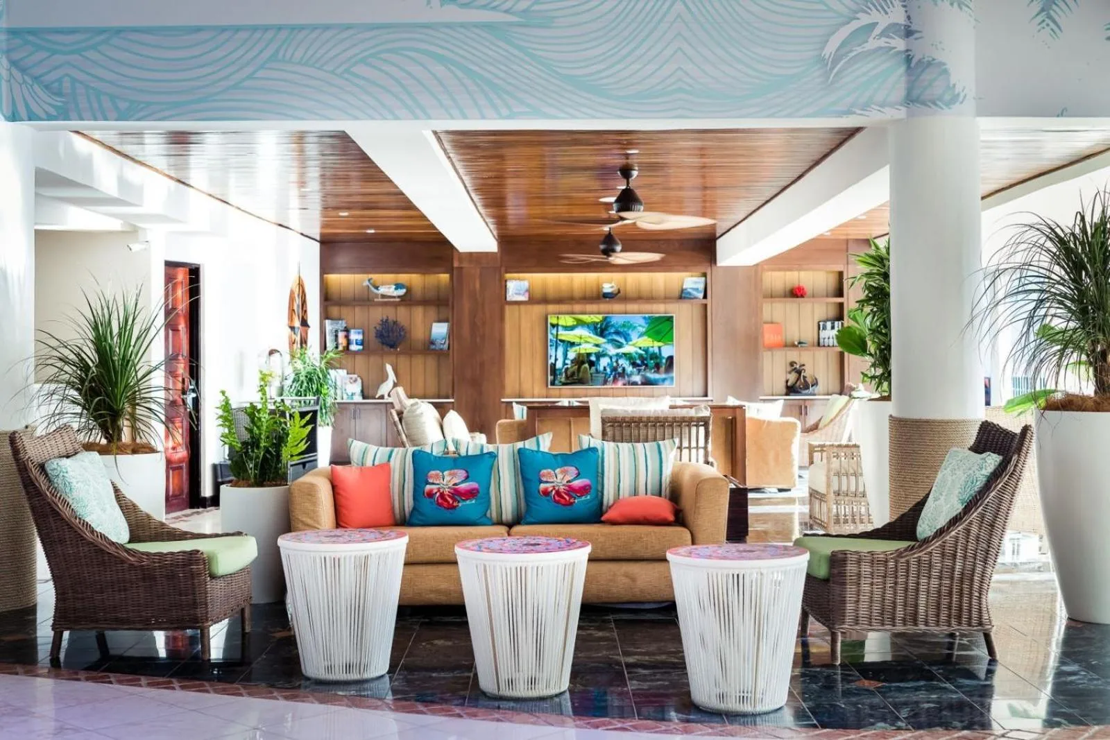 Lobby seating with wicker chairs and tropical decor at Margaritaville Beach Resort Playa Flamingo.