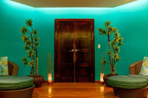 Spa-style lounge entry with teal walls and double doors at Margaritaville Beach Resort Playa Flamingo.