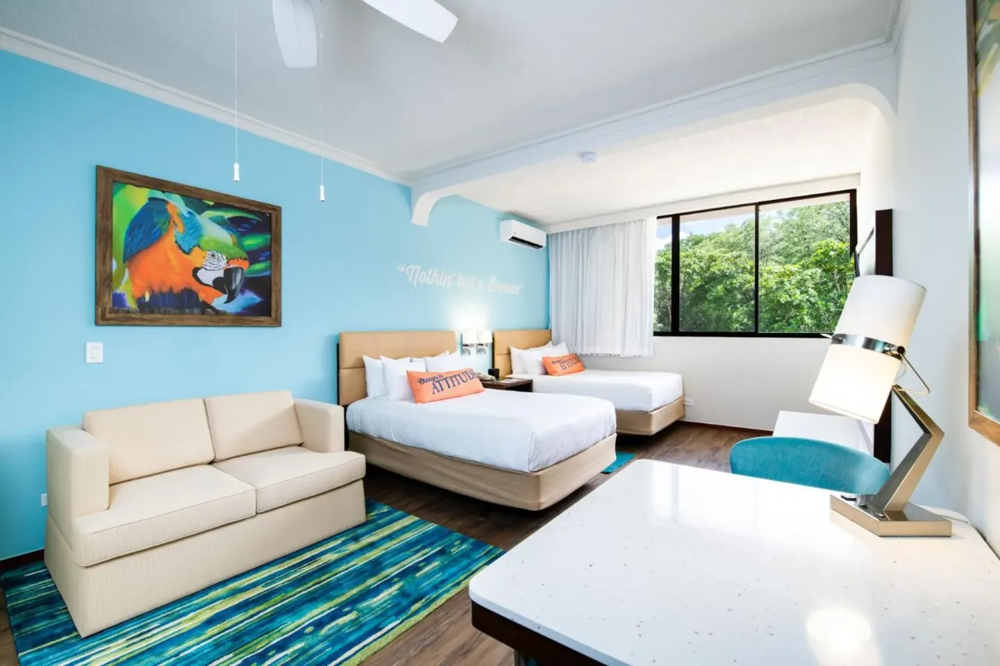 Two-bed guest room with sofa at Margaritaville Beach Resort Playa Flamingo.