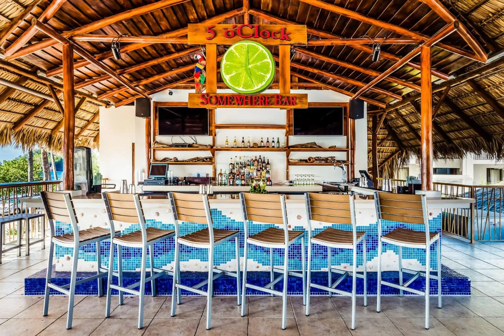 Thatched 5 O'Clock Somewhere bar with stools at Margaritaville Beach Resort Playa Flamingo.