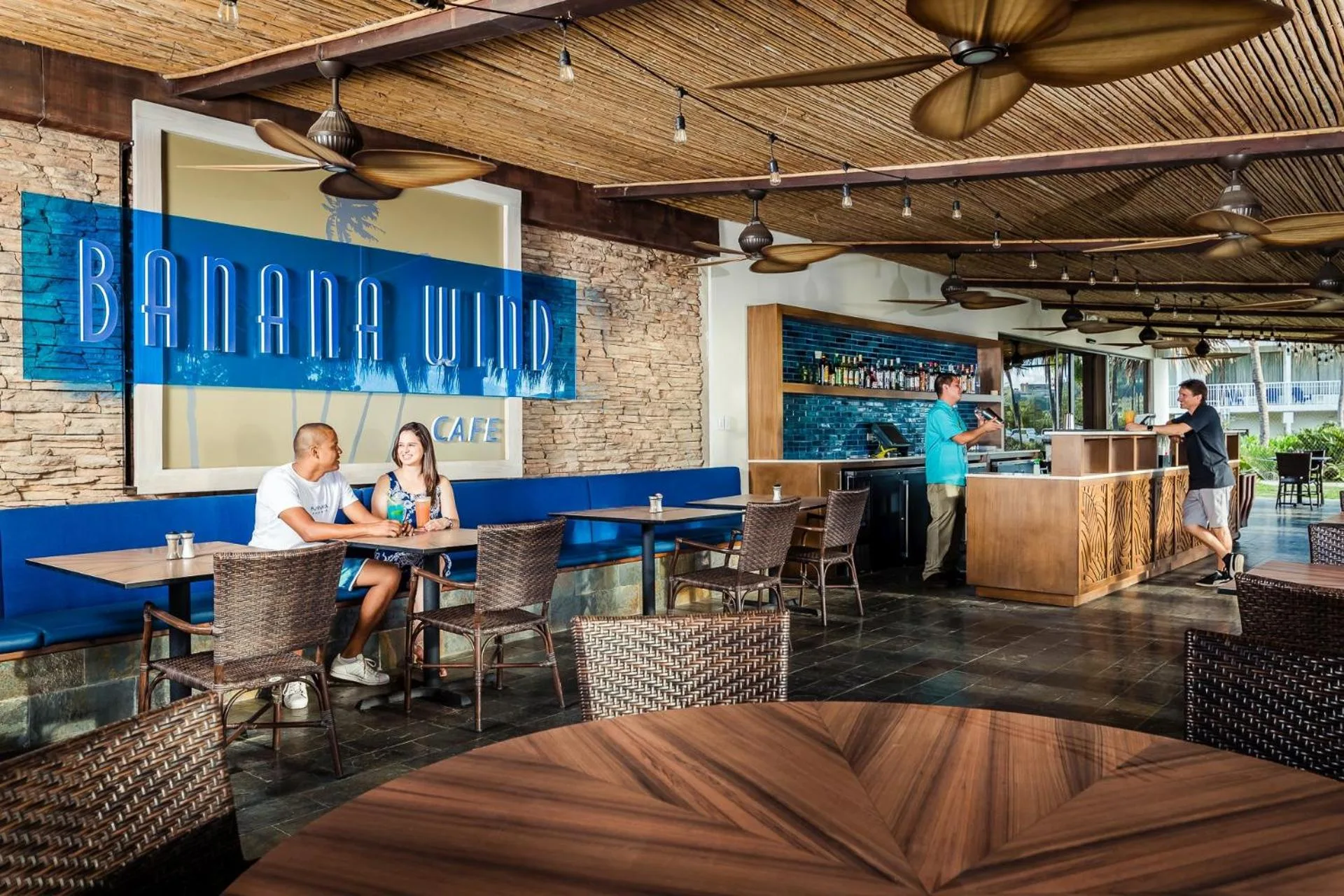 Banana Wind Cafe seating and bar area at Margaritaville Beach Resort Playa Flamingo.