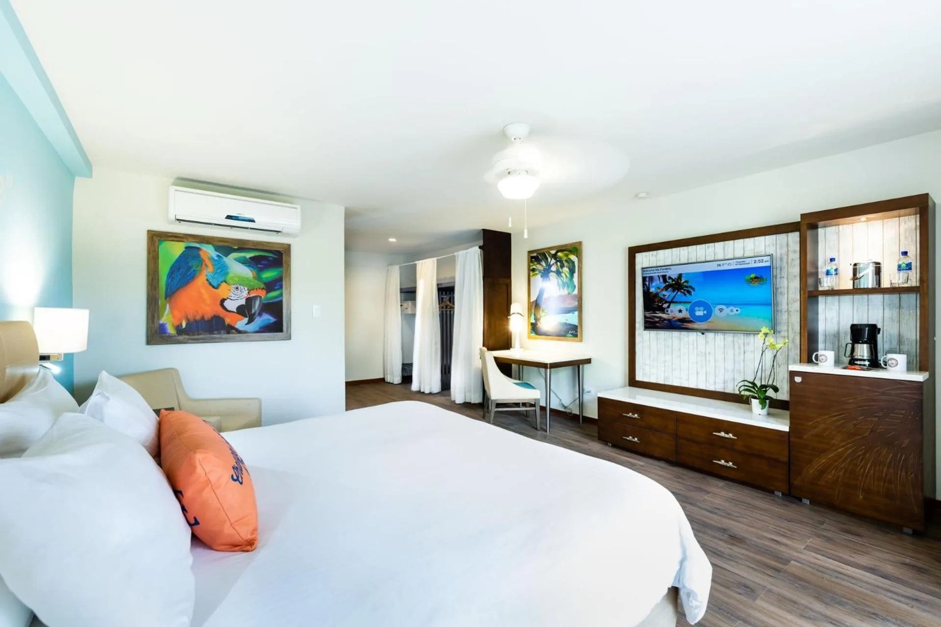Standard Room king bed and media wall at Margaritaville Beach Resort Playa Flamingo.