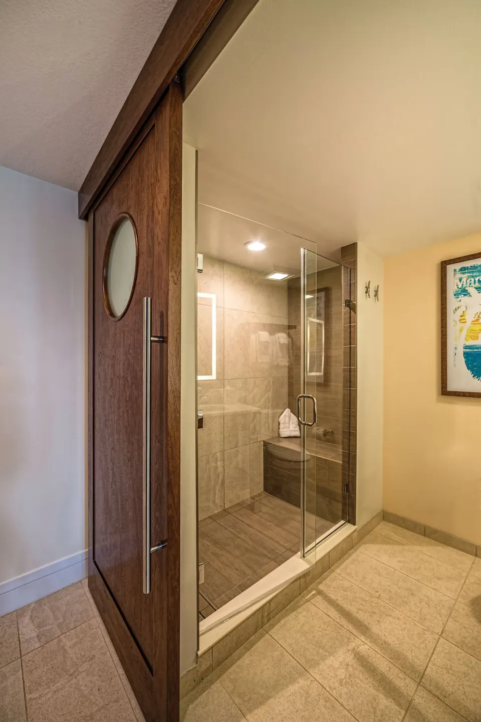 Guest bathroom shower with sliding wood door at Margaritaville Vacation Club - St. Thomas.