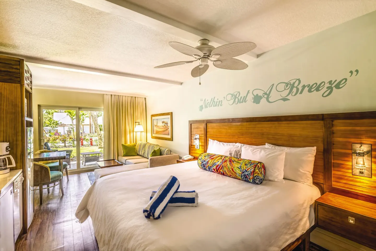 King bed guest room with sitting area at Margaritaville Vacation Club - St. Thomas.