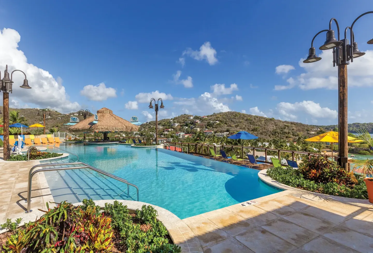 Hillside-view pool with colorful umbrellas at Margaritaville Vacation Club - St. Thomas.