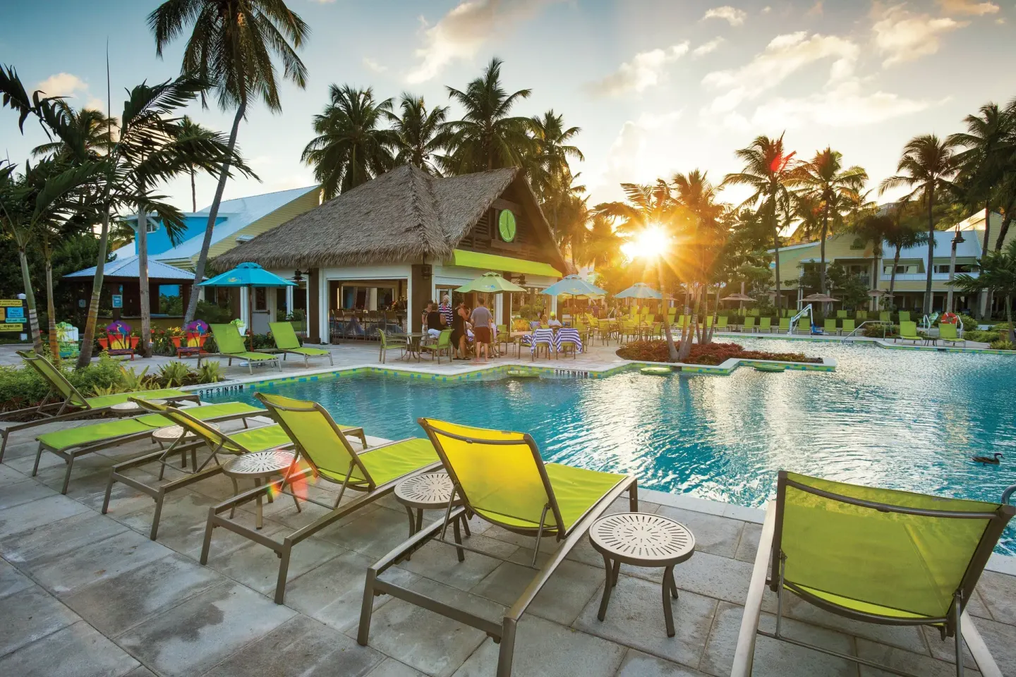 Sunset over the pool and thatched poolside bar at Margaritaville Vacation Club - St. Thomas.