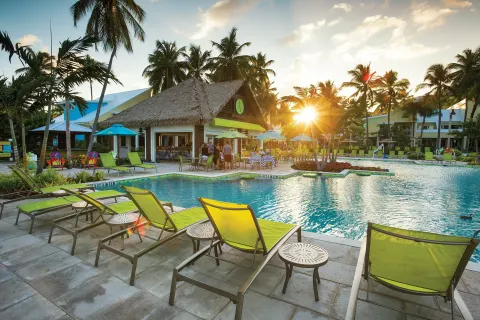 Sunset over the pool and thatched poolside bar at Margaritaville Vacation Club - St. Thomas.