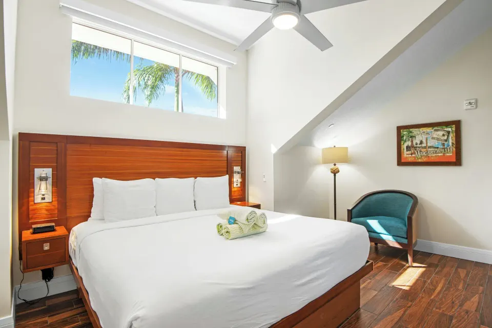 Standard 1 Bedroom condo king bed under high windows at Margaritaville Vacation Club - St. Thomas.