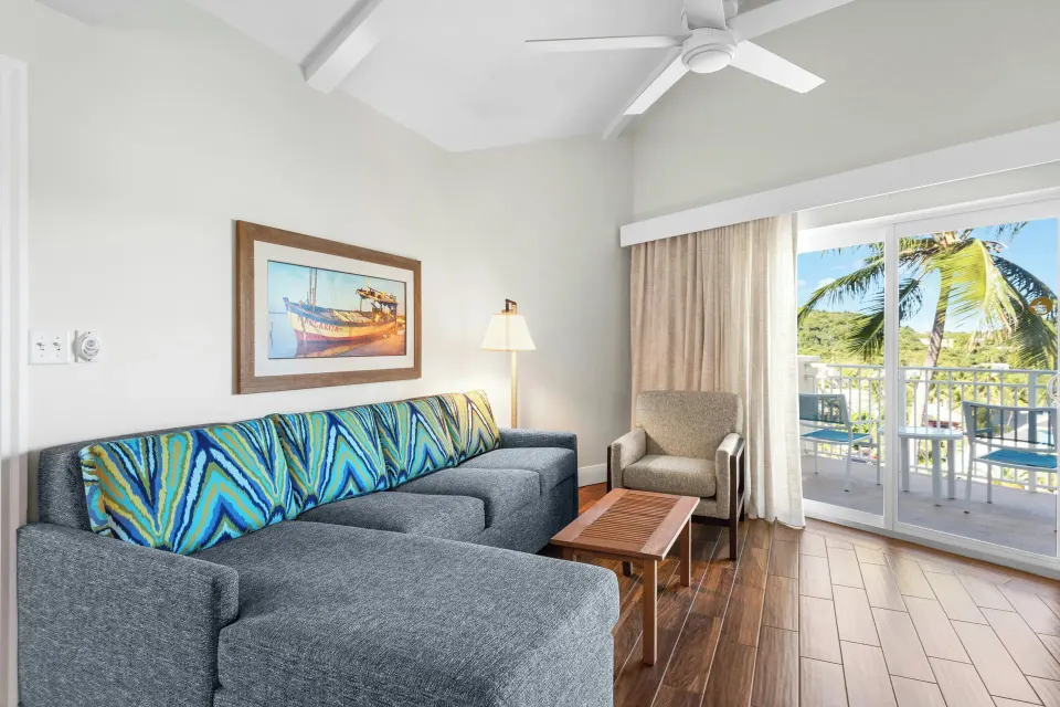 Standard 1 Bedroom condo lounge with balcony doors at Margaritaville Vacation Club - St. Thomas.