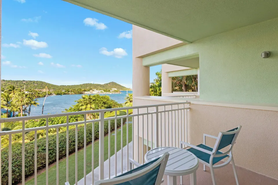 Studio suite balcony with water and hillside view at Margaritaville Vacation Club - St. Thomas.