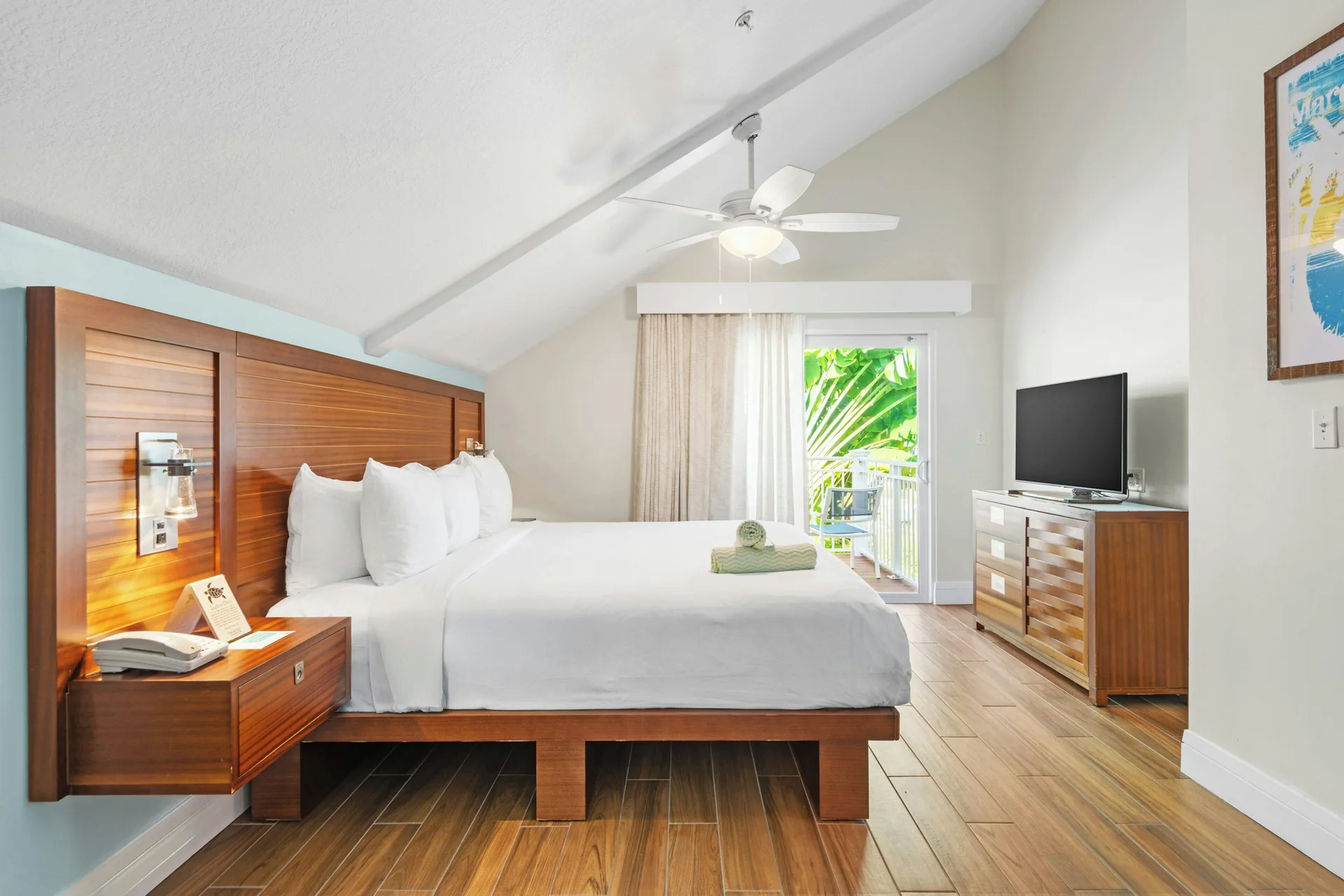 Studio Suite king bed and balcony door at Margaritaville Vacation Club - St. Thomas.