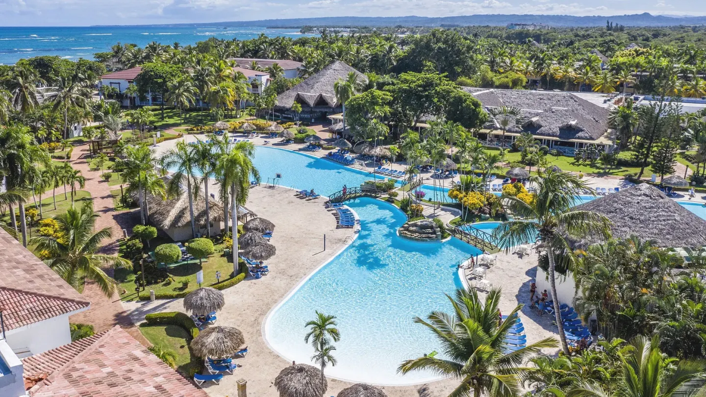 Aerial view of the pool, palms, and coastline at Marien Puerto Plata.