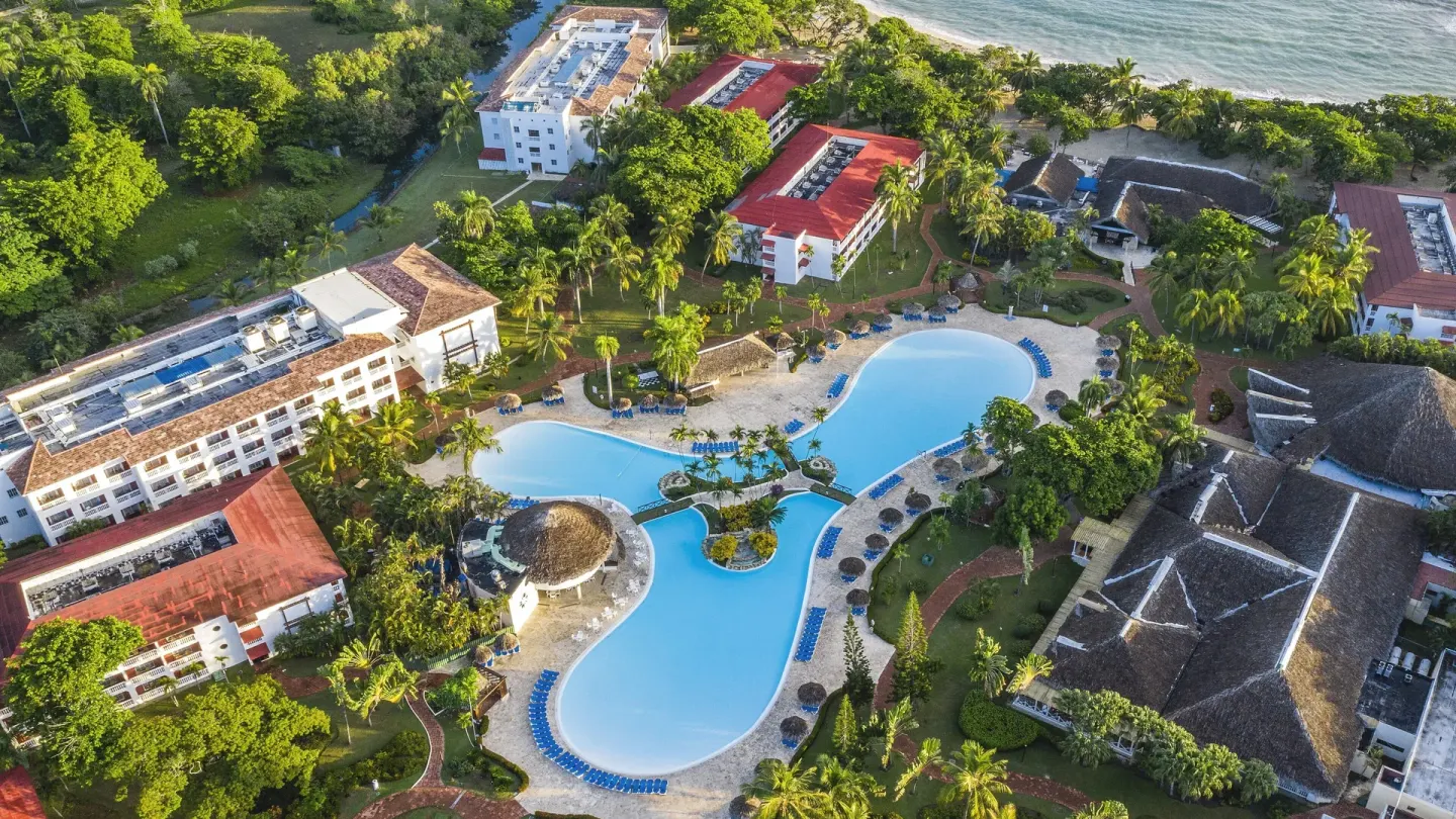 Aerial view of pools, palms, resort buildings and beach at Marien Puerto Plata.