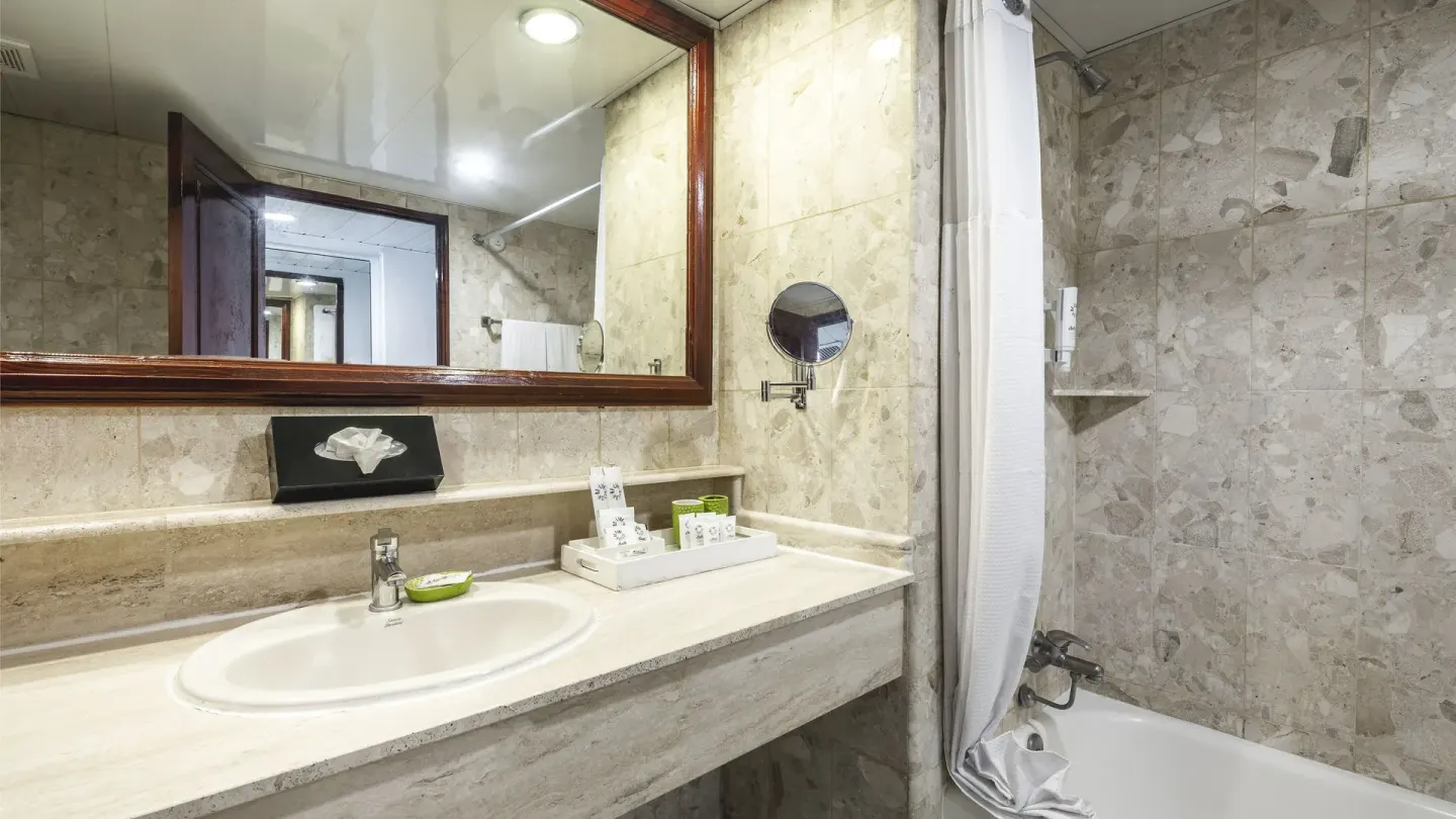 Guest bathroom with sink, amenities and bathtub shower at Marien Puerto Plata.